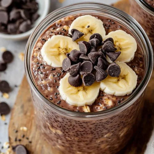 Chocolate banana overnight oats in jar with toppings