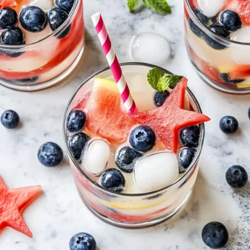 Overhead Patriotic Lemonade with watermelon stars, blueberries & striped straw.
