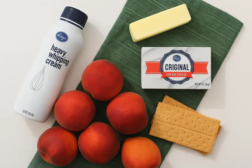 Flat-lay of peaches, cream cheese, whipped cream, butter, and graham crackers